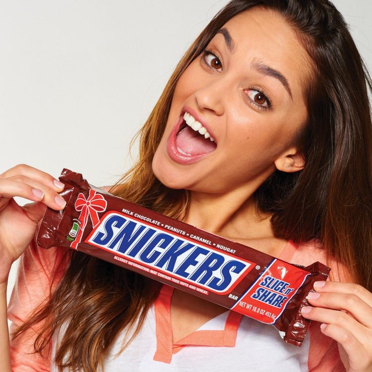 Layers of roasted peanuts, caramel, and nougat covered in milk chocolate make a Snickers bar one of the tastiest candy bars in the world