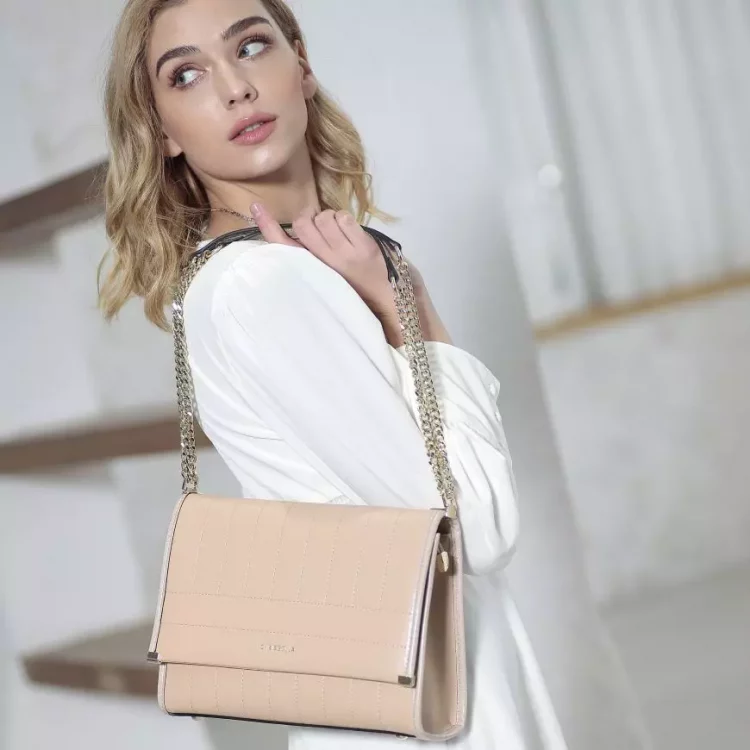 Shoulder bag is a handbag or purse with at least one strap attached to it that is long enough to fit over the shoulder
