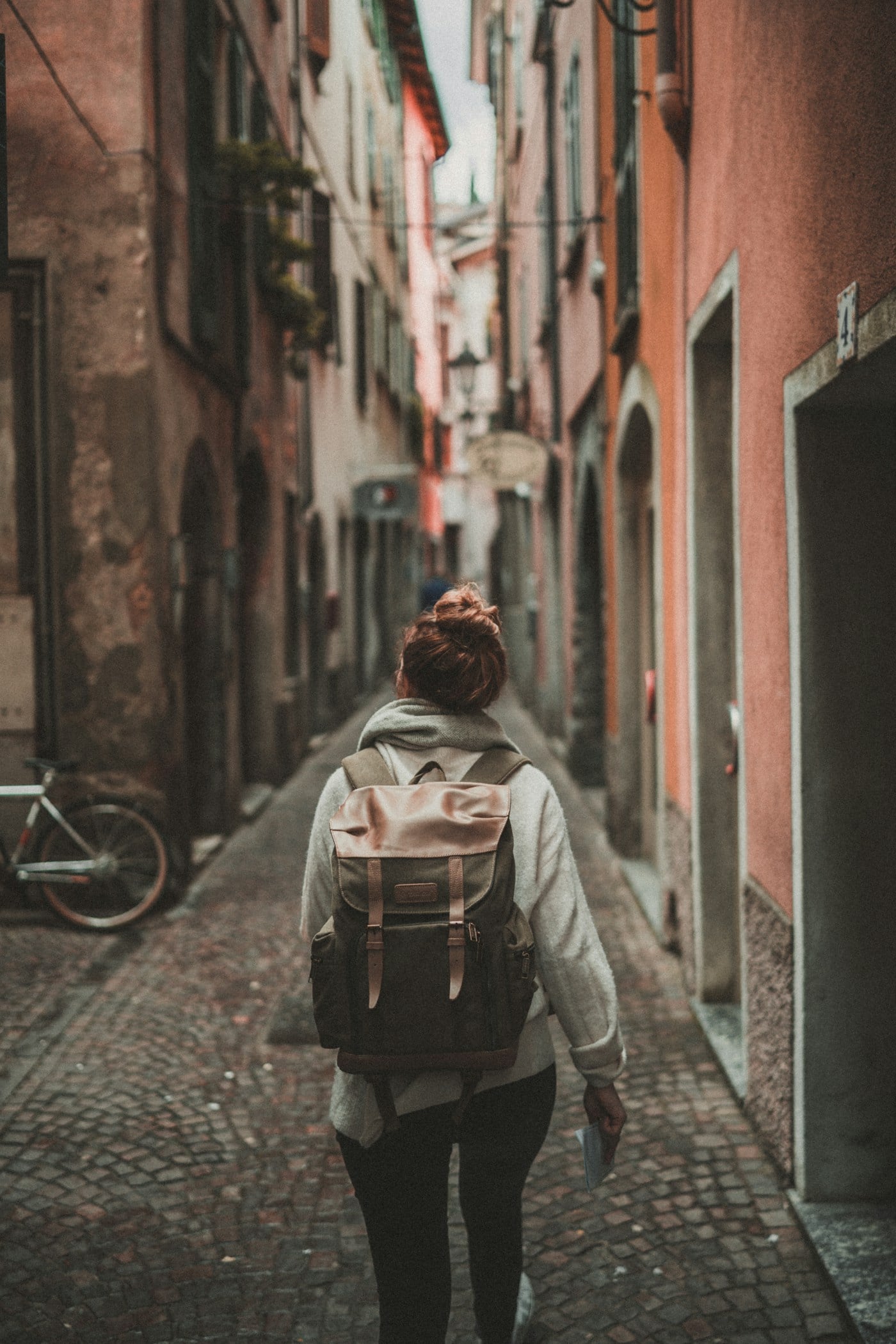 Backpacker walking through a narrow alley