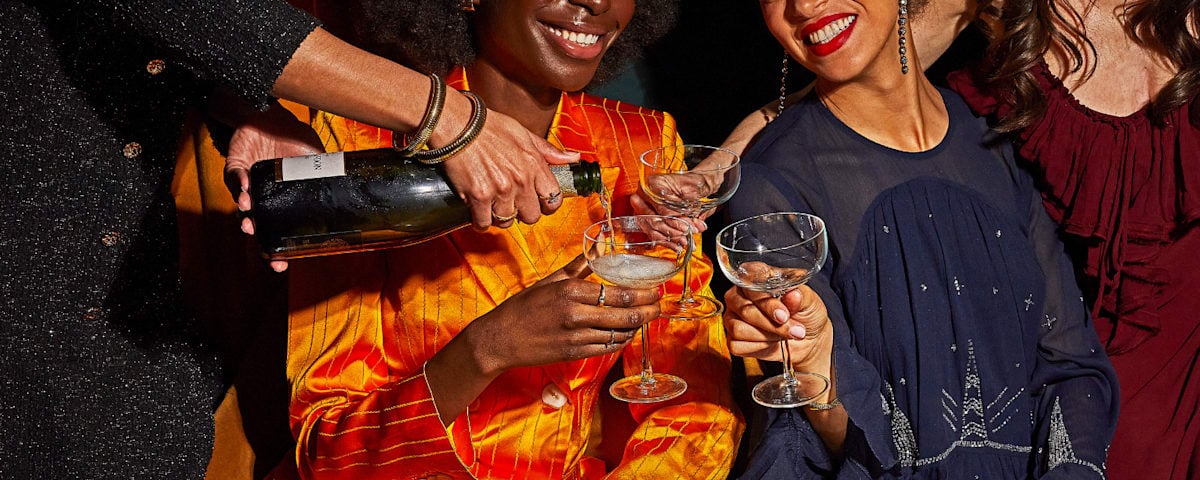 Guests being welcomed with champagne in an Ambassador Lounge