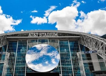 AT&T Stadium exterior and glass roof viewed from the surrounding grounds