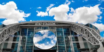 AT&T Stadium exterior and glass roof viewed from the surrounding grounds