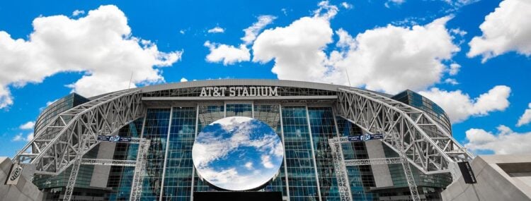AT&T Stadium exterior and glass roof viewed from the surrounding grounds