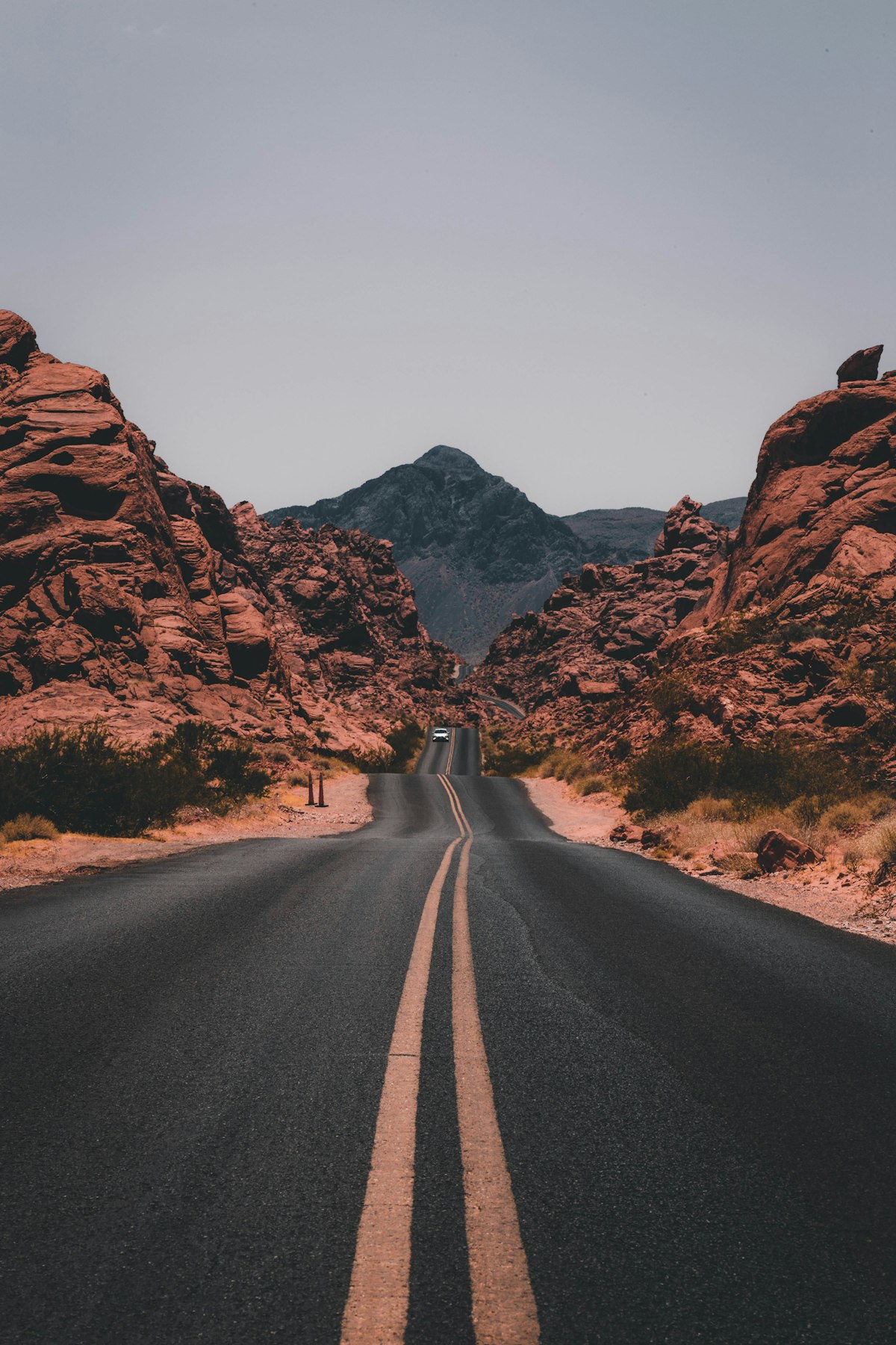 Desert road winding between rocky cliffs