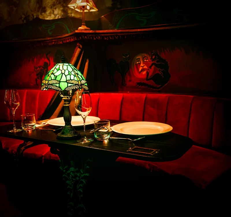 Luxury upholstered booth seating at Chat Noir