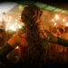 Cabaret performer seen from inside a candlelit Parisian club