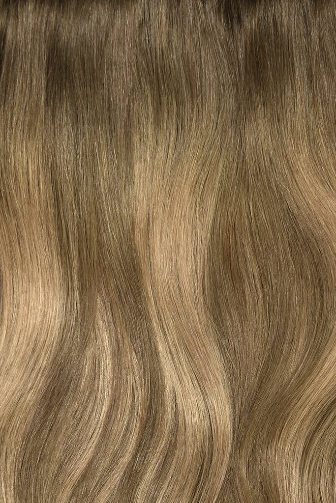 Close-up of soft bronze wavy hair texture from Cliphair extensions