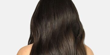 Long dark wavy hair showing a voluminous Cliphair extension style