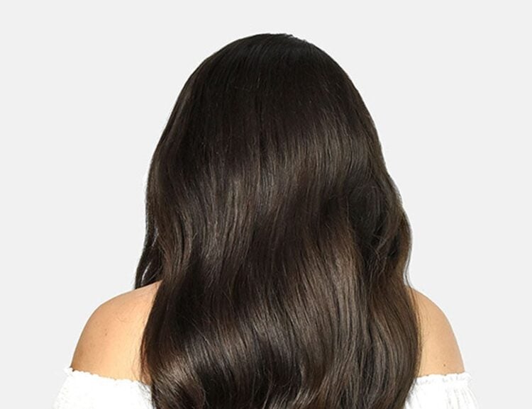 Long dark wavy hair showing a voluminous Cliphair extension style