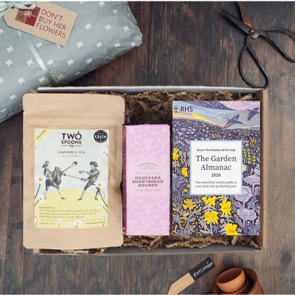 The contents of a gardening gift box with a book and refreshments