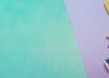Children's gift pencils arranged on a green and purple background