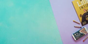 Children's gift pencils arranged on a green and purple background