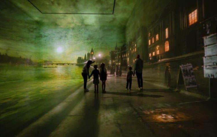 Visitors exploring a colorful immersive gallery at Frameless in London