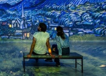 Visitors sitting inside an immersive art gallery at Frameless