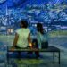 Visitors sitting inside an immersive art gallery at Frameless