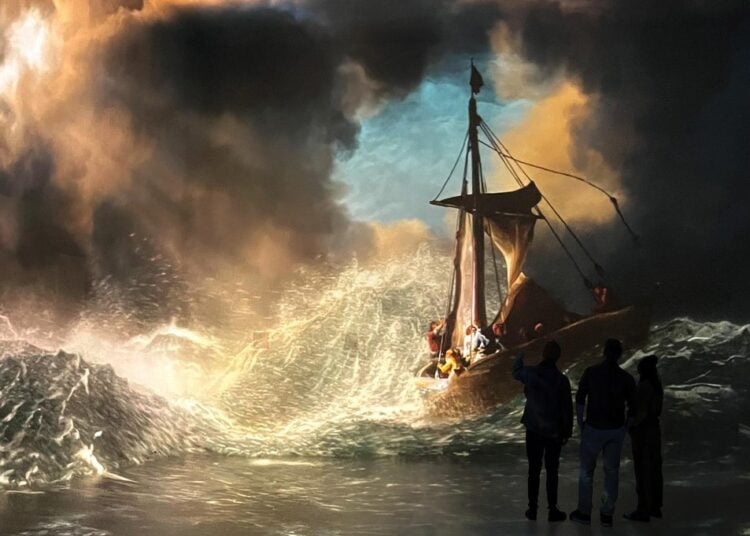 Visitors surrounded by a projected Rembrandt seascape in the World Around Us gallery