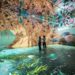 Two people standing inside FRAMELESS immersive art experience