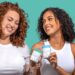 Two women smiling while holding Happy V wellness products