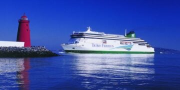 Irish Ferries ferry sailing near a lighthouse