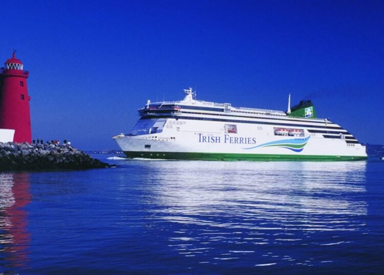 Irish Ferries ferry sailing near a lighthouse