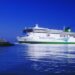 Irish Ferries ferry sailing near a lighthouse