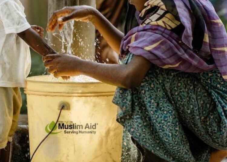 Family receiving clean water support through Muslim Aid