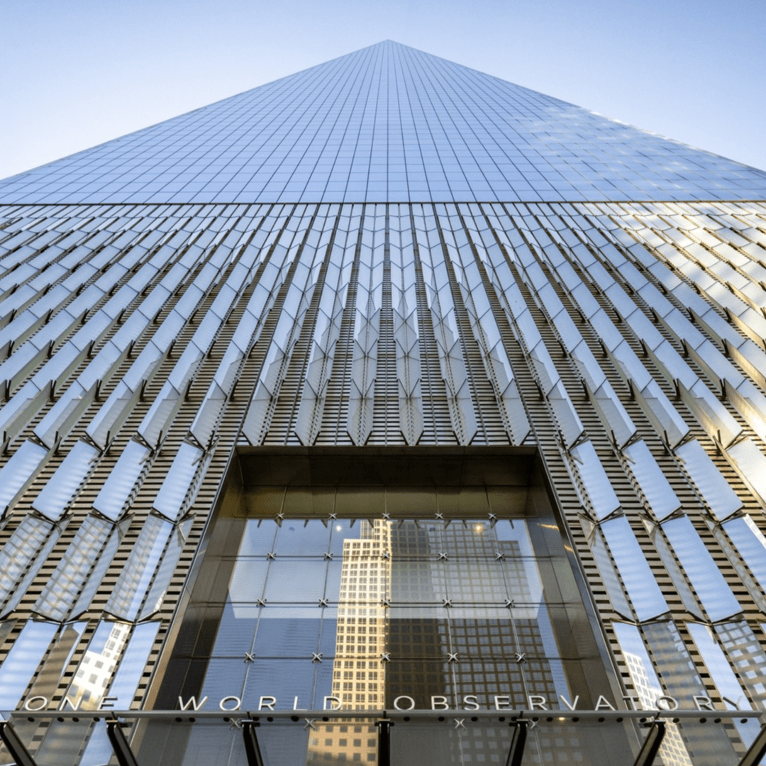 One World Trade Center rising above a Lower Manhattan street