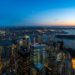 Wide sunset panorama of New York Harbor and Lower Manhattan from above