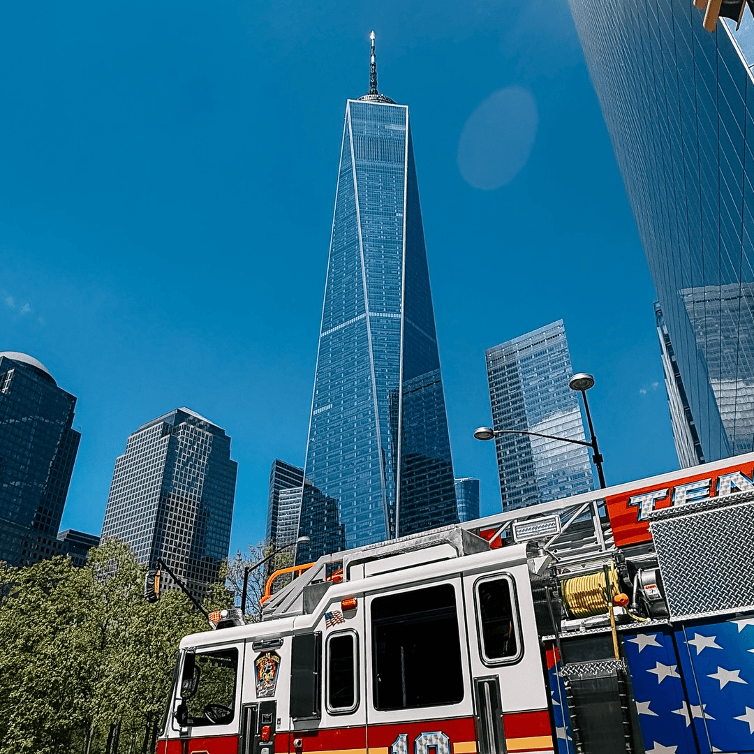 One World Trade Center viewed from street level beside a fire truck