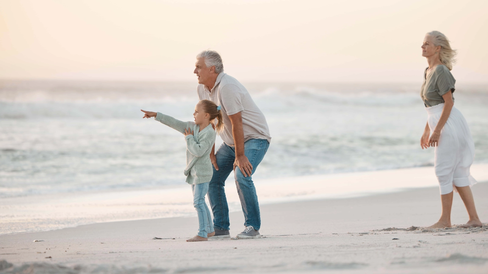 Grandfather and granddaughter enjoying a beach holiday