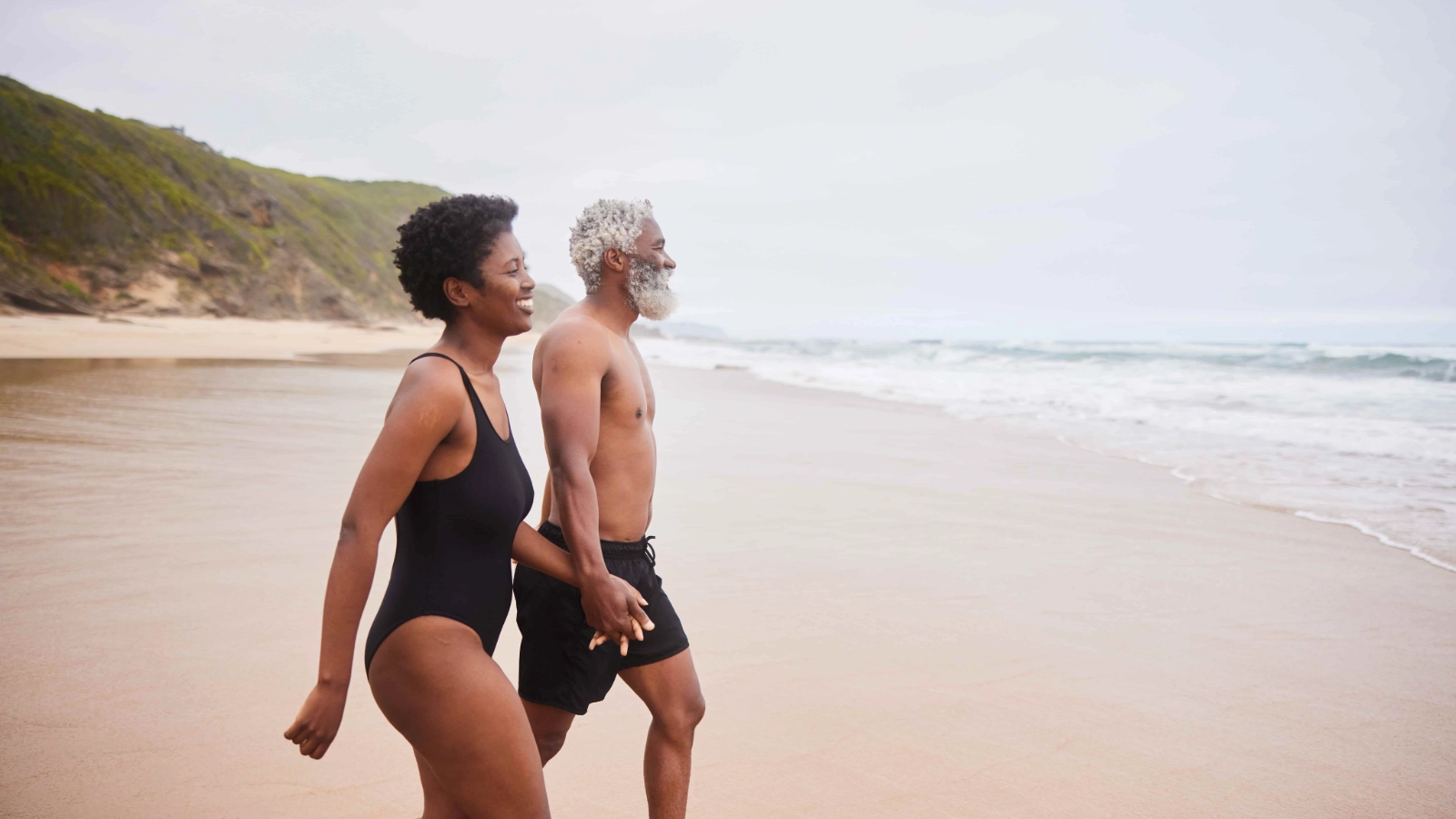 Older couple holding hands on holiday