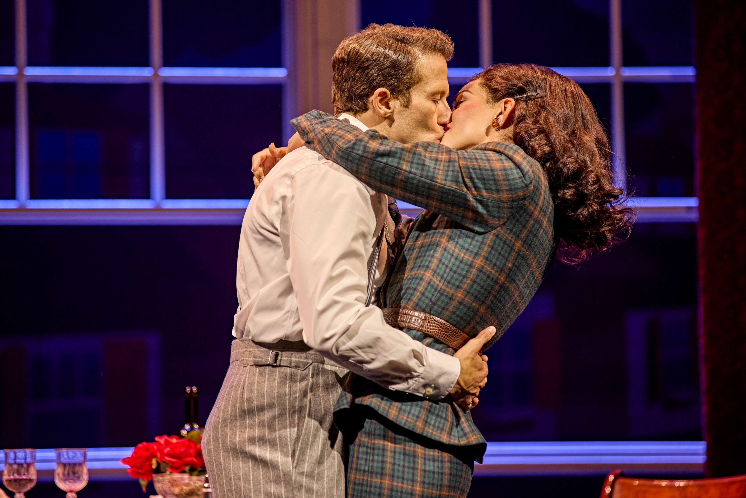 Two performers kissing onstage in Sinatra The Musical