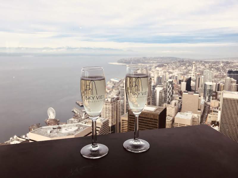 Champagne glasses over a Seattle view at Sky View Observatory
