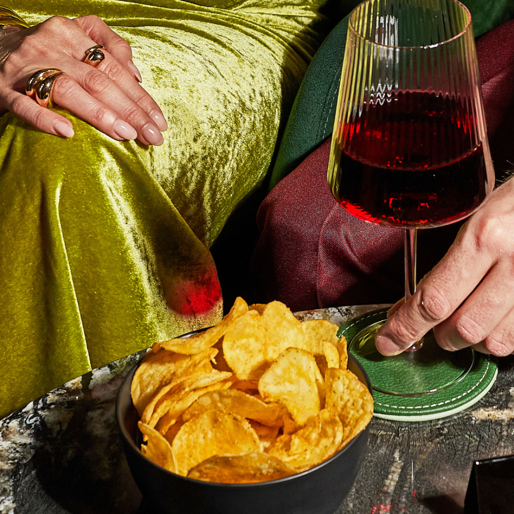 Wine glass and chips arranged for a theatre visit
