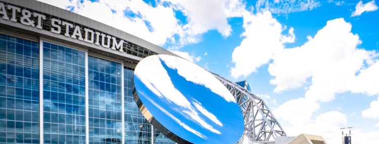 AT&T Stadium exterior with the Sky Mirror sculpture under a blue sky
