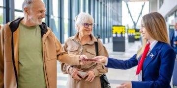 Airport staff assisting travellers with luggage