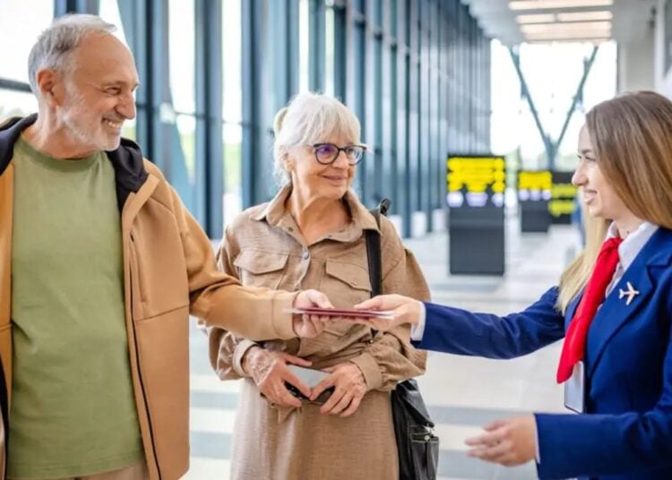 Airport staff assisting travellers with luggage