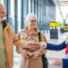 Airport staff assisting travellers with luggage