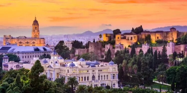 Warm sunset over Malaga rooftops for an autumn travel route