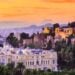 Warm sunset over Malaga rooftops for an autumn travel route
