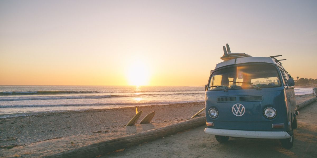 Campervan parked beside a beach
