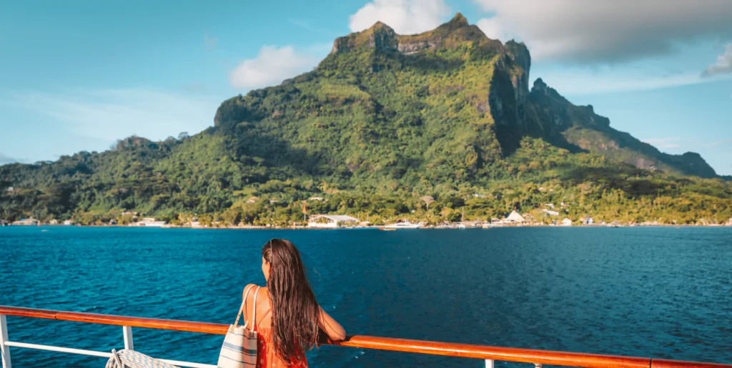 Woman viewing a tropical island from a holiday setting