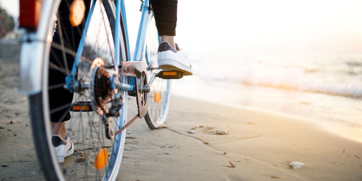 Cyclist riding beside a beach