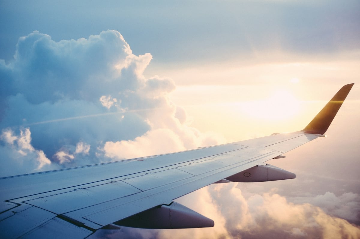 Airplane wing above clouds during a journey