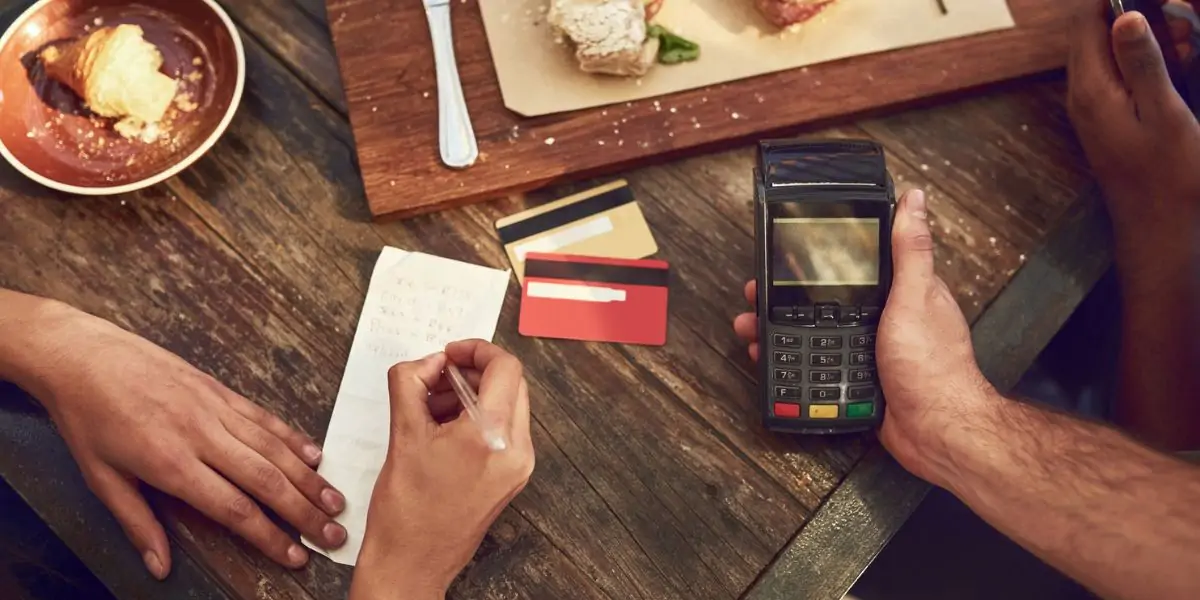 Traveller paying at a restaurant abroad