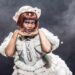 Cabaret performer in a white costume on stage