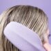 Person using the Cliphair Wet One detangling hairbrush