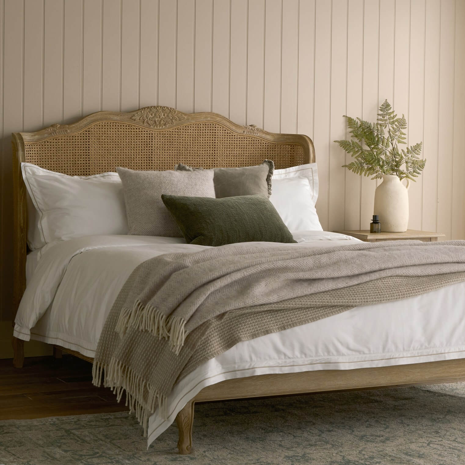 Chamonix rattan bed with a weathered oak frame