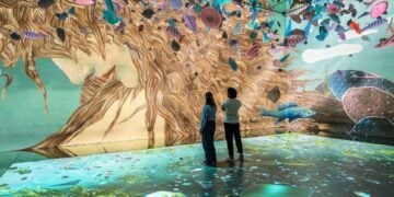 Visitors surrounded by the Dawn of Venus projection inside Frameless