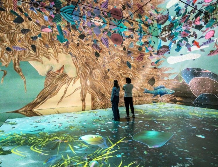 Visitors surrounded by the Dawn of Venus projection inside Frameless